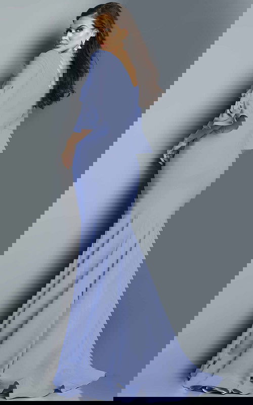 Back view of model wearing 09776 gown in periwinkle blue, showcasing the mermaid silhouette.