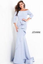 Model showcasing Jovani 00446 light blue mermaid gown with ruffle and off-the-shoulder neckline.
