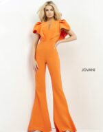 Model showcasing Jovani 00762 orange jumpsuit with notched neckline.