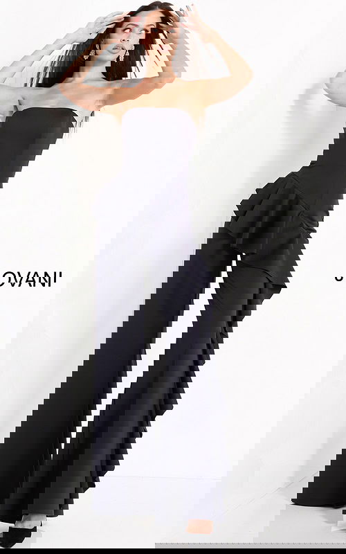 Model showcasing the Jovani 00778 strapless navy jumpsuit with ruffles.