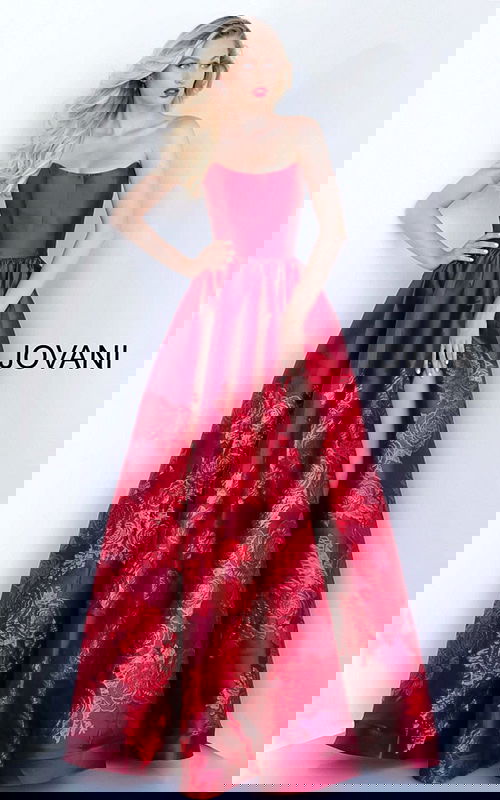 Model wearing Jovani 02038 elegant ball gown with floral embroidery and high slit.