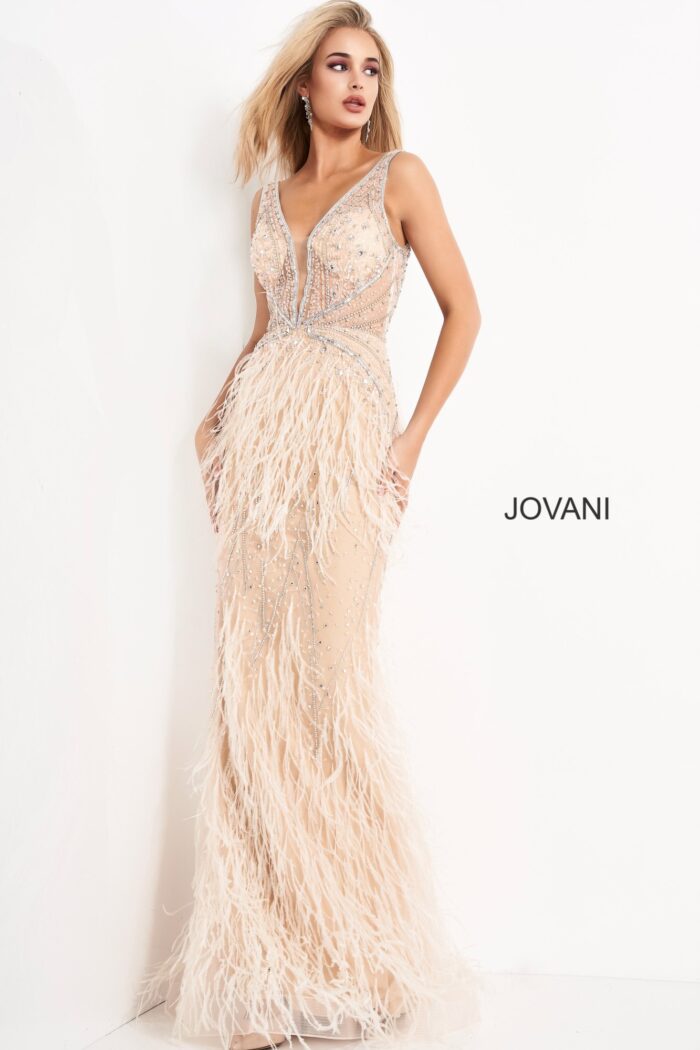 Model wearing Jovani 03023 blush beaded gown with feather embellishments.