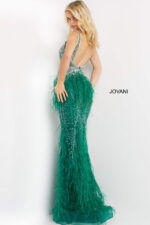 Back view of model in Jovani 03023 green gown with feathered skirt.