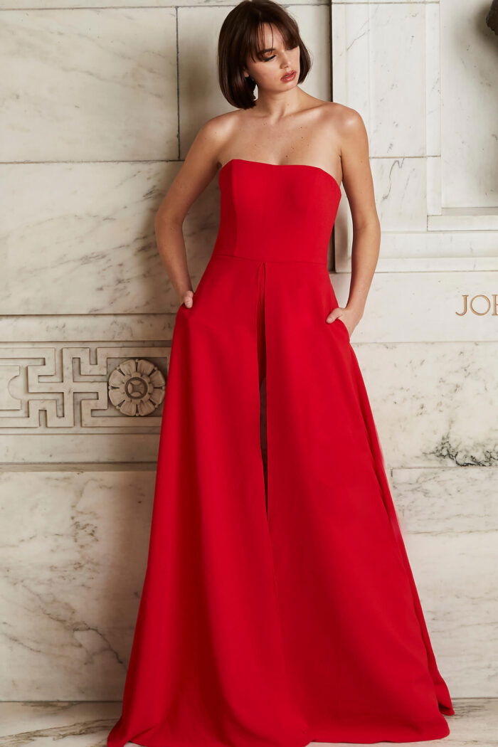 Model wearing Jovani 03529 red jumpsuit, full front view, highlighting the chic strapless fit and wide-leg structure.