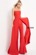 Model wearing Jovani 03529 red jumpsuit, angled view, showcasing the wide-leg cut and elegant overlay.