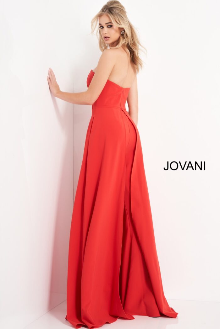Model wearing Jovani 03529 red jumpsuit, back view, emphasizing the strapless design and flow of the wide-leg cut.