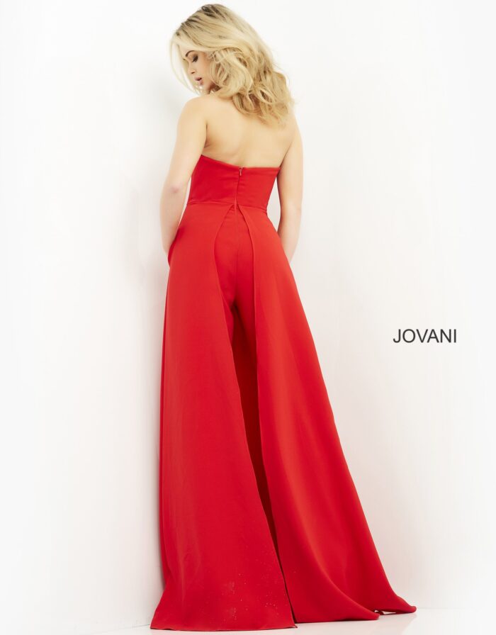 Model wearing Jovani 03529 red jumpsuit, back view, showcasing the flowing wide-leg cut.