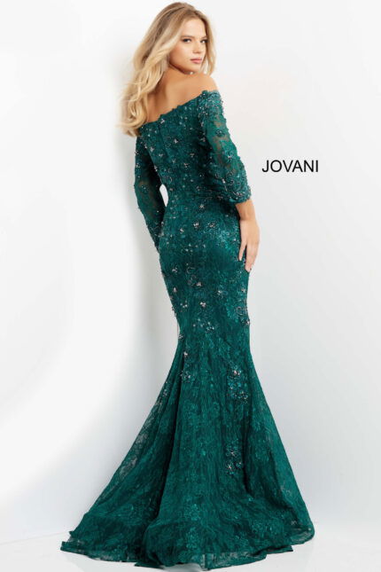 Model in Jovani 03651 emerald gown back view showcasing fitted mermaid silhouette with lace and embellishments.