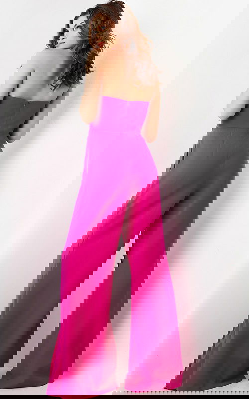 Model wearing Jovani 03828 fuchsia strapless jumpsuit with wide-leg pants, back view.