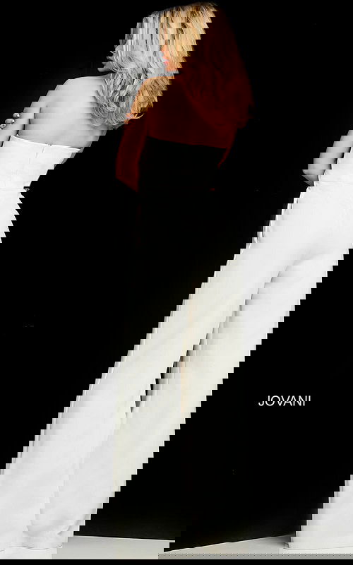 Model wearing Jovani 03828 ivory strapless jumpsuit back view with flowing pants.