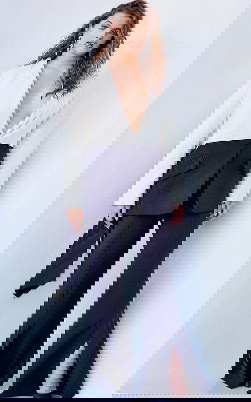 Model wearing Jovani 04148 black and ivory jumpsuit with wide-leg silhouette, front view.