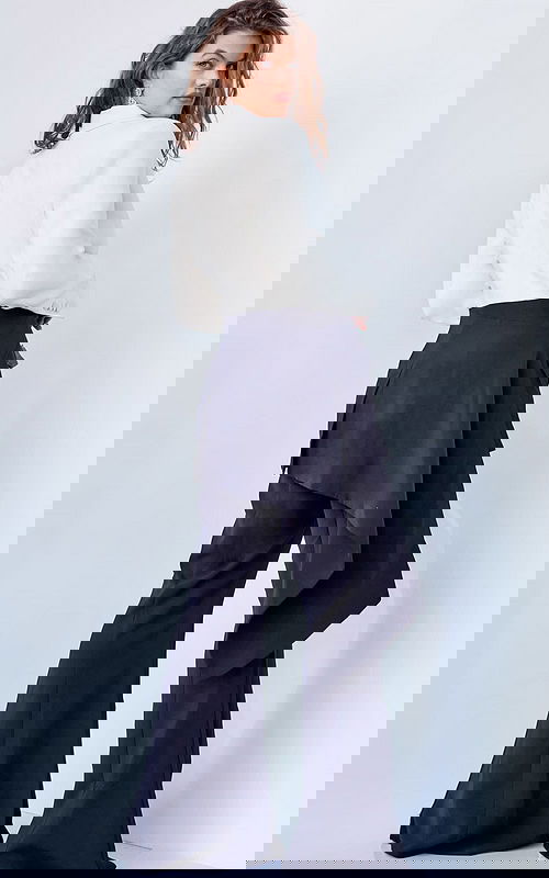 Model wearing Jovani 04148 black and ivory jumpsuit, back view showing blazer-style detail.