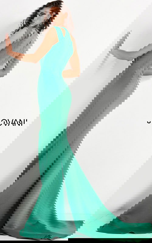 Back view of model wearing Jovani 04222 green gown with flowing hem.