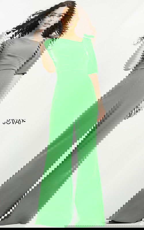 Model wearing Jovani 04284 emerald green jumpsuit with wide-leg pants and square neckline, front view.
