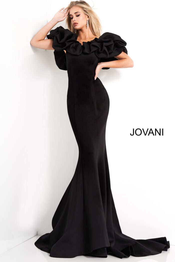 Model wearing Jovani 04368 black mermaid gown with ruffled sleeves, front view.