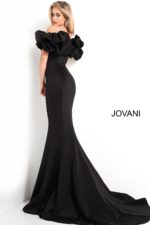 Model wearing Jovani 04368 black mermaid gown with ruffled sleeves, back view.