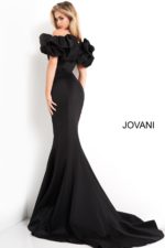 Model wearing Jovani 04368 black mermaid gown with ruffled sleeves, back view.