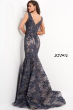 Model wearing Jovani 04585 navy lace mermaid gown, back view with zipper.