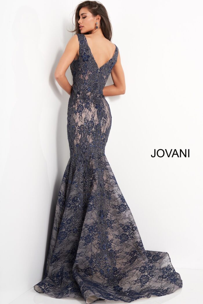Model wearing Jovani 04585 navy lace mermaid gown, back view with zipper.