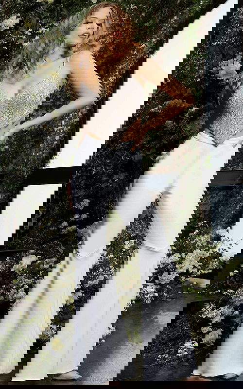 Model wearing Jovani 05307 featuring shimmering V-neckline and flared pants