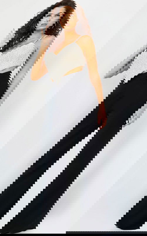 Model wearing Jovani 05307 black dress with embellished top, front view.