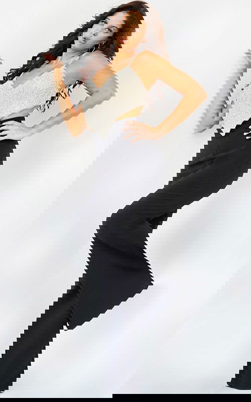 Model wearing Jovani 05307 black dress with embellished top, side view.