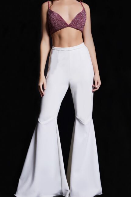 Model in Jovani 05308 white pants with beaded top, front view.