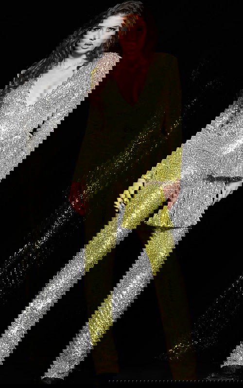 Model wearing Jovani 05345 yellow sequin jumpsuit with V-neckline and long sleeves.