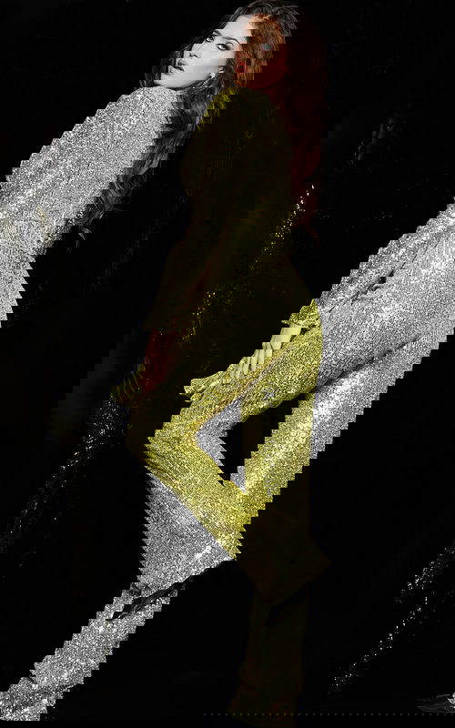 Back view of model wearing Jovani 05345 yellow sequin jumpsuit with peplum detail.