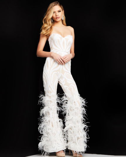 Model wearing Jovani 05669 white jumpsuit with sweetheart neckline and feathered hem.