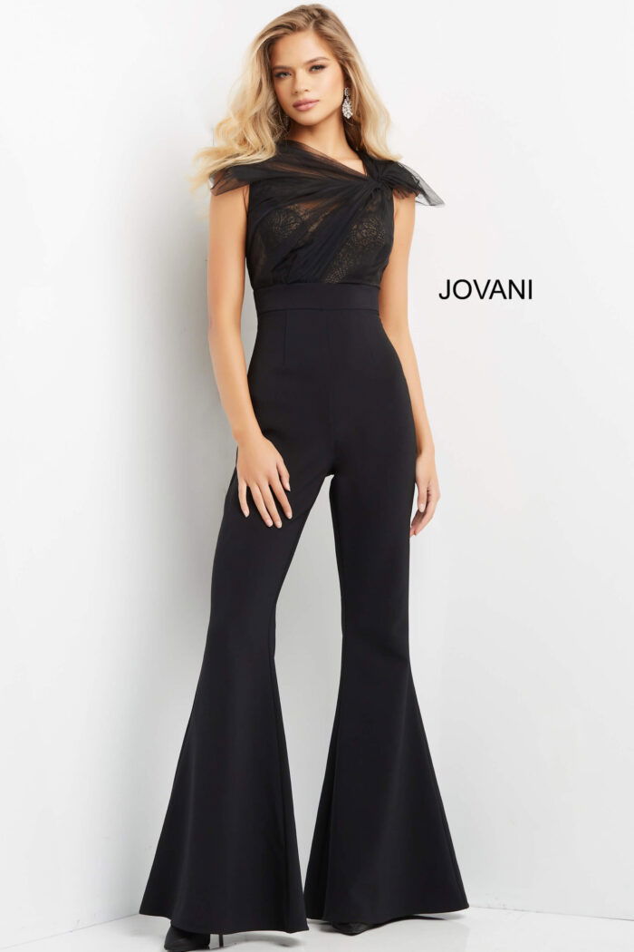 Front view of model in Jovani 05676 black jumpsuit with sheer lace overlay.