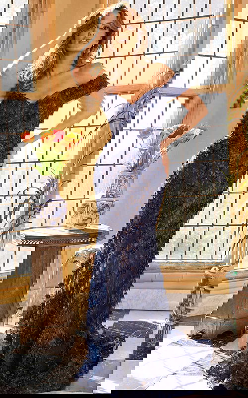 Model wearing Jovani 06169 navy dress with floral lace appliques and off-shoulder neckline.