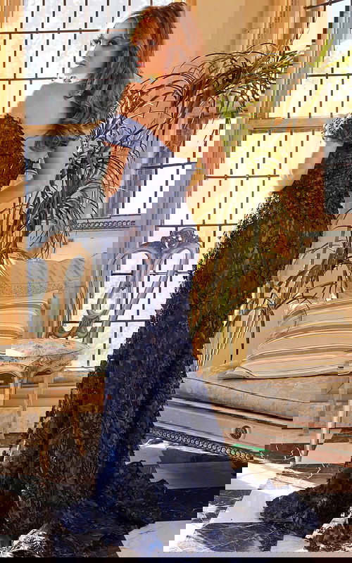 Model showing the back of Jovani 06169 navy dress with intricate lace details.