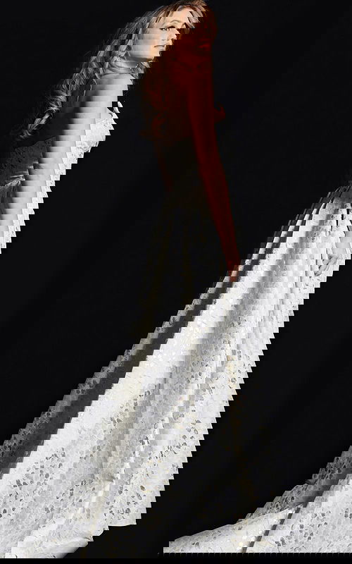 back view of model in 06255 beige gown with textured pattern