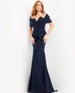 Model wearing Jovani 06403 navy blue gown with off-the-shoulder neckline.