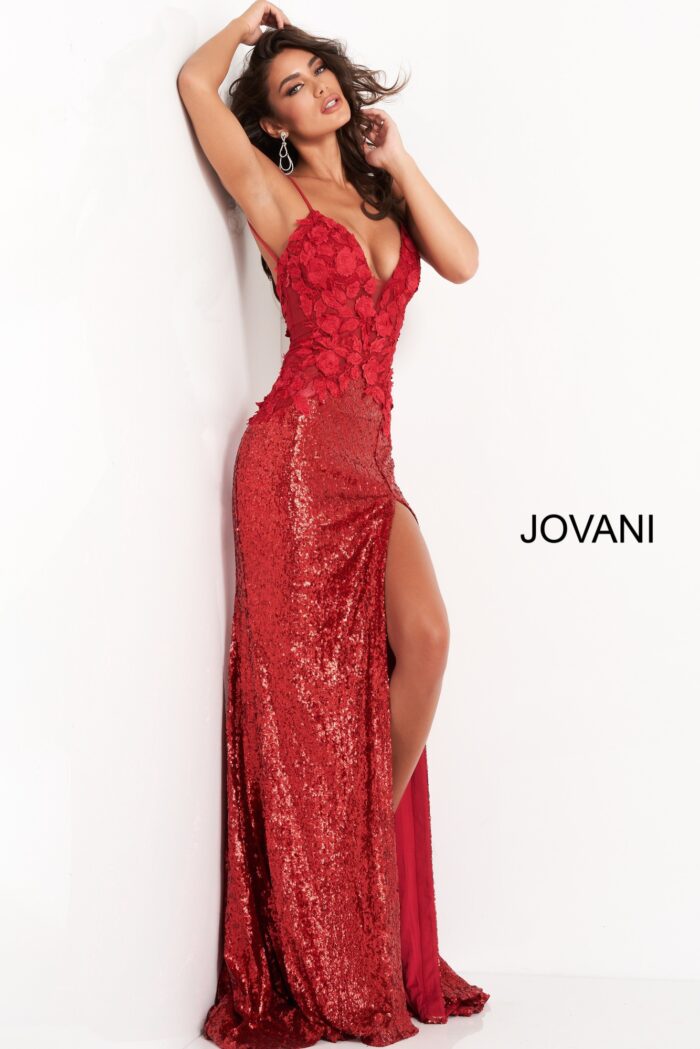 Model wearing Jovani 06426 red gown with floral bodice and high slit, front view.