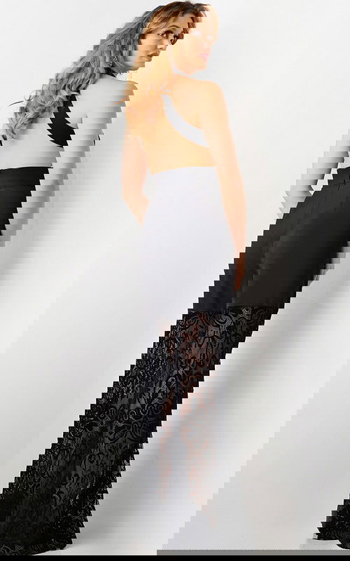 Model wearing Jovani 06612 black dress, back view with open back design.