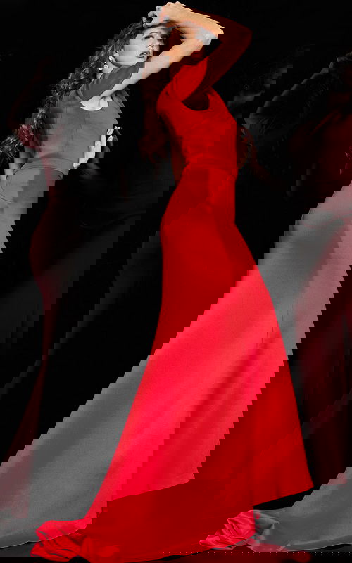 Model wearing Jovani 06753 red one-shoulder mermaid gown, back view.