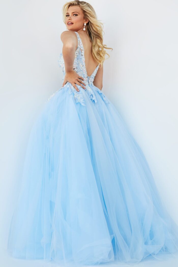 Model wearing Jovani 06808 blue gown showcasing the tulle flow and intricate back detail, back view.