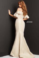 Model in Jovani 06831 beige dress, back view, highlighting elegant mermaid silhouette.