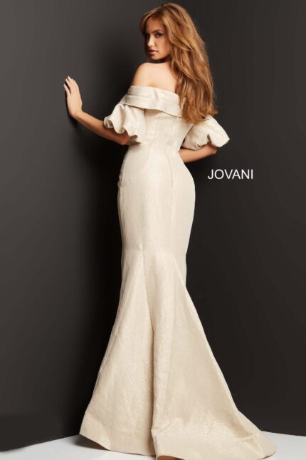 Model in Jovani 06831 beige dress, back view, highlighting elegant mermaid silhouette.