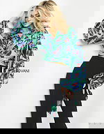 model wearing Jovani 06844 Print top with butterfly print and long sleeves