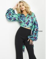 Model wearing Jovani 06844 vibrant print ensemble with crop top and long sleeves.