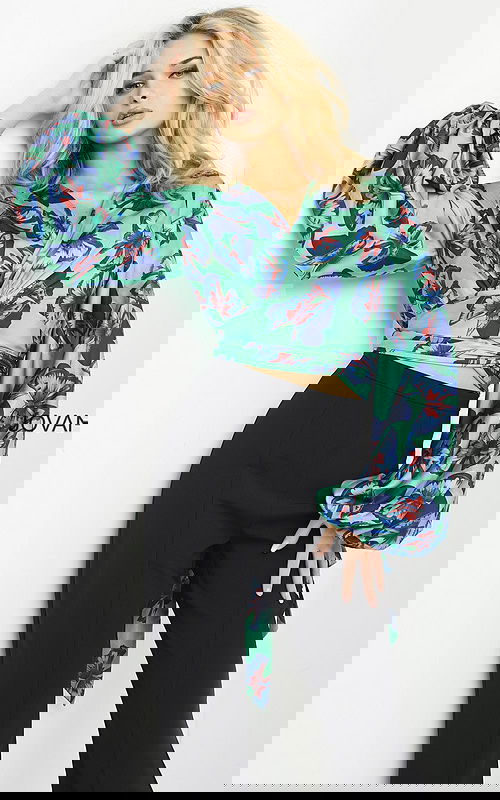 Model wearing Jovani 06844 vibrant print ensemble with crop top and long sleeves.