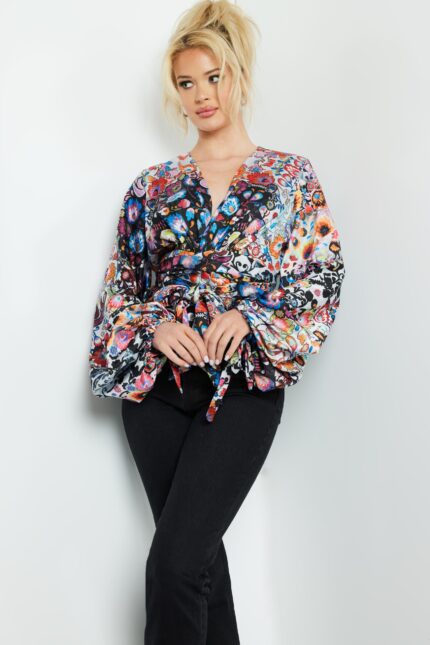 Model wearing Jovani 06847 vibrant print wrap top with V-neckline