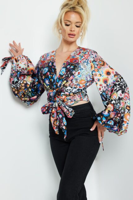 Model showcasing Jovani 06847 vibrant wrap top with billowy sleeves