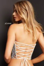 Rear view of model in Jovani 06855 white dress highlighting lace-up detail.