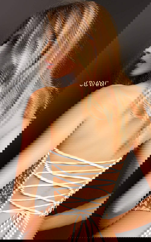 Rear view of model in Jovani 06855 white dress highlighting lace-up detail.