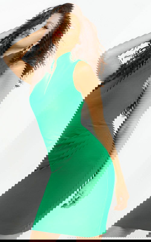 Model wearing 06975 elegant green dress featuring a high neck and sleeveless design, front view.