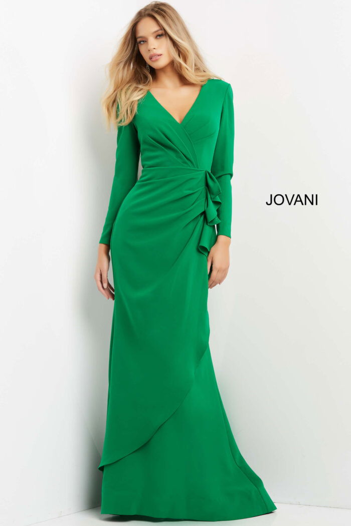 Model wearing Jovani 06995 emerald green dress with V-neckline and long sleeves.